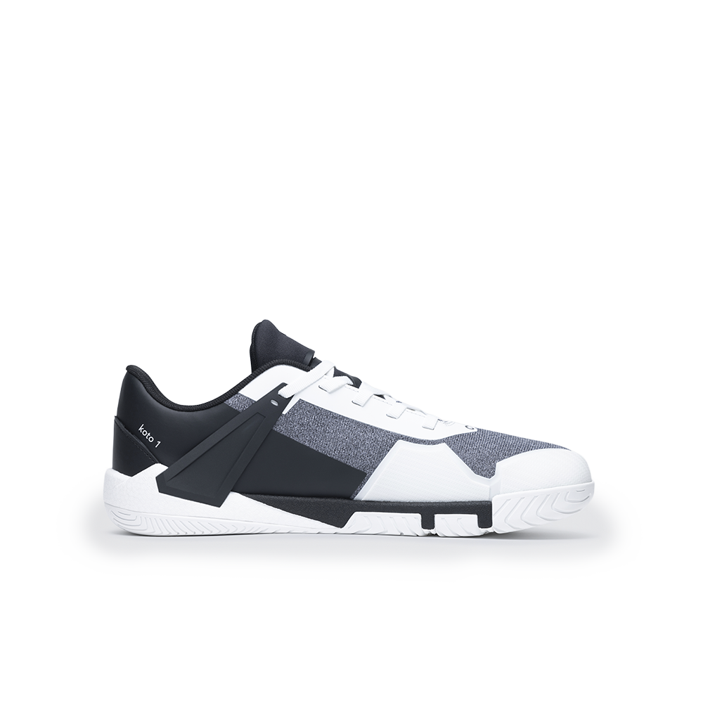 Black and white sneaker with a strap on a white background