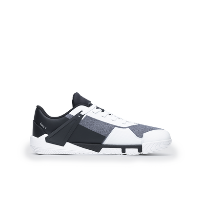 Black and white sneaker with a strap on a white background